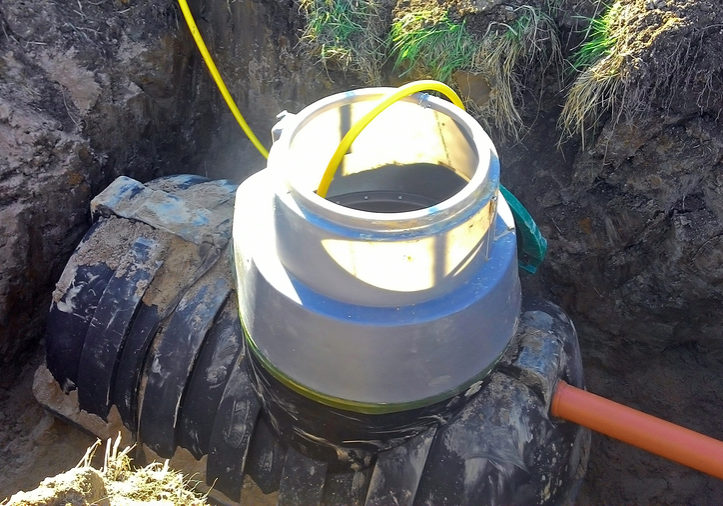 Plumbing drain pipe is being connected to septic tank for waste treatment