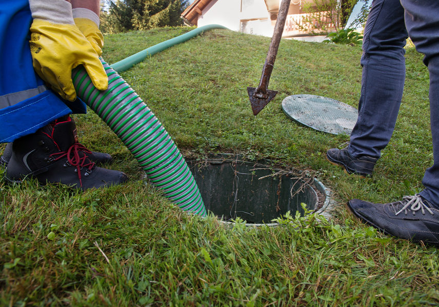 Emptying household septic tank. Cleaning sludge from septic system.